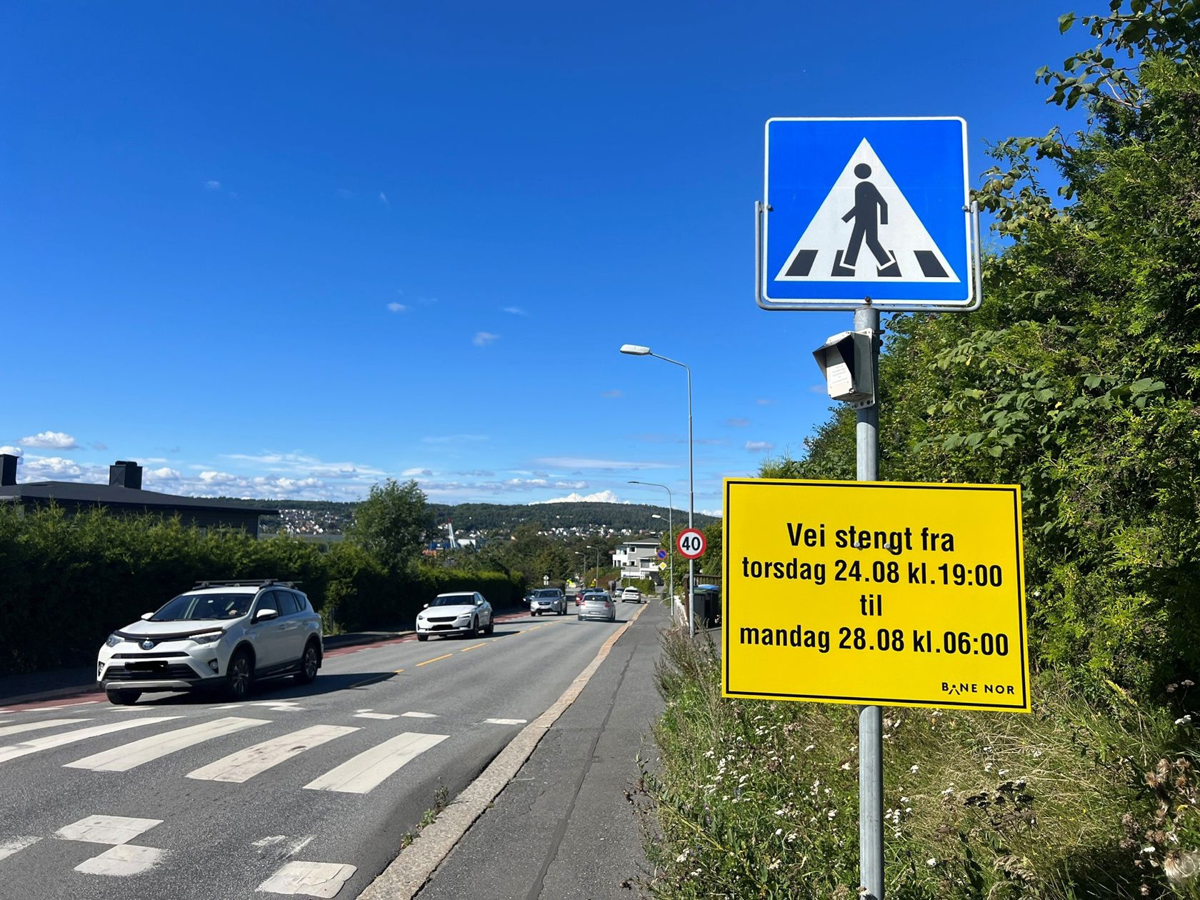 Bilde av Fjordveien og skilt med informasjon om stengt vei.